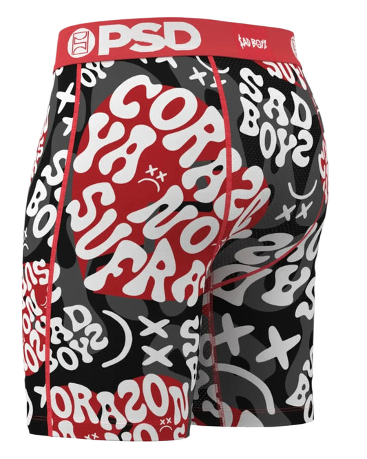 Black athletic shorts with red and white text and graphics, featuring the brand 'PSD'.