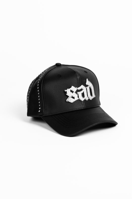 Black cap with 'sad' text on a white background